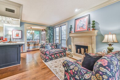 This is a great home for entertaining! Large living room with fireplace, large bar area. Features dental crown molding, updated paint, beautiful framed windows.