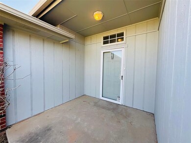 Doorway to property with a patio area