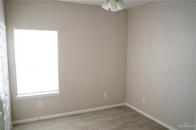 Empty room with light wood-type flooring, baseboards, and a ceiling fan