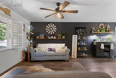 Living room with ceiling fan and wood finished floors
