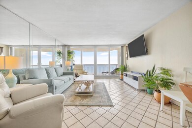 Tiled living room with a wall of windows