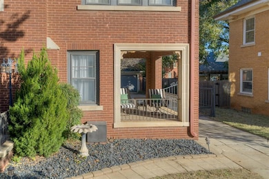 Entrance to property featuring brick siding