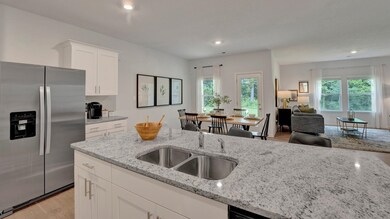 Kitchen featuring stainless steel refrigerator wit