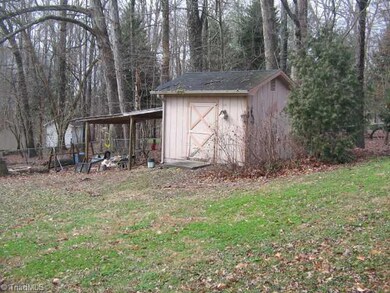 Storage. View of fenced back yard and storage building