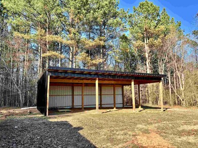 View of pole building with a detached carport and 