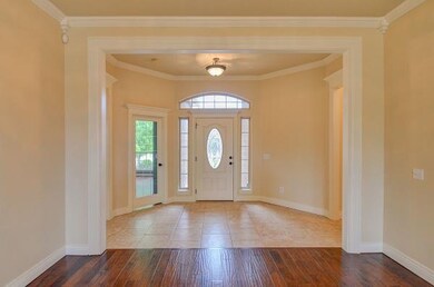LIVING ROOM to FOYER:  Notice the wood encased ent