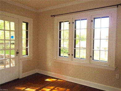 The sunroom has glass french doors the lead to 2 p
