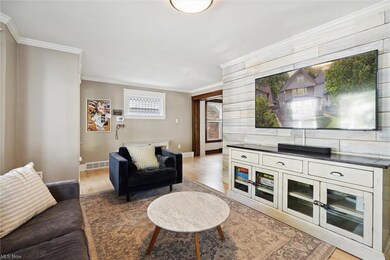 Spacious living room showcases a beautifully restored fireplace, leaded glass windows and striking wood feature wall.