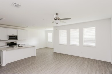 Kitchen featuring white cabinets, backsplash, stainless steel appliances, light hardwood / wood-style flooring, and sink