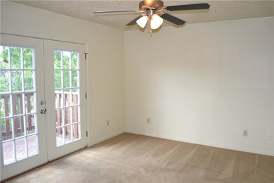 Empty room with light carpet, a healthy amount of