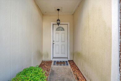 The covered front entrance with light fixture prov