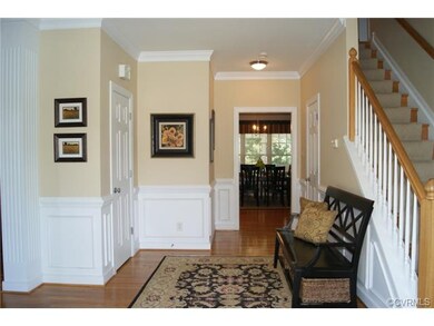 Huge foyer with offset stairs, crown & picture fra