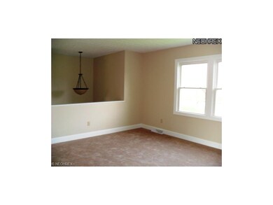 Formal living room with paint, carpet, & windows.