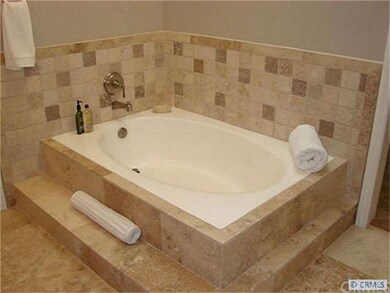 Master bath with custom travertine tile work.