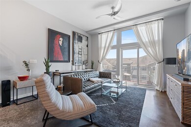 Living room with ceiling fan and finished concret