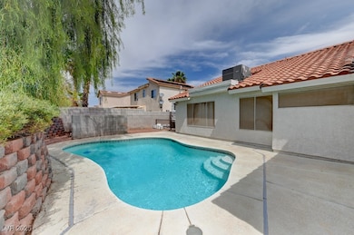 View of pool with a fenced backyard, a patio, and