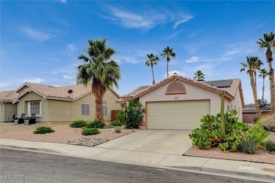 Single story home featuring a garage, a tile roof,