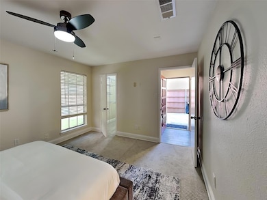 Carpeted bedroom featuring baseboards, a ceiling f