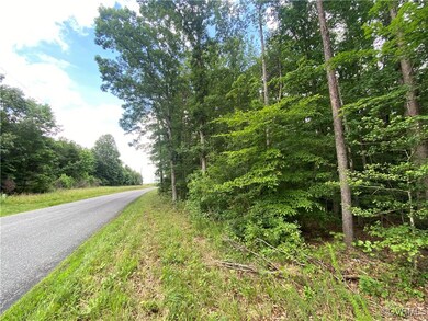 View of asphalt road with a wooded view