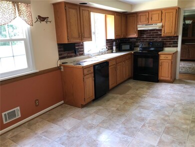 Oak kitchen with dinette area. Vinyl flooring. All