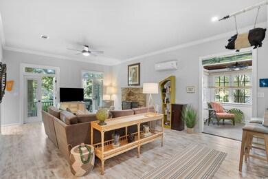 Living room with a fireplace, light hardwood / woo