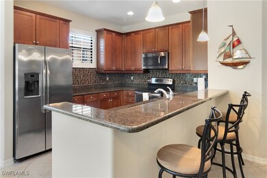 Kitchen with light tile patterned flooring, applia