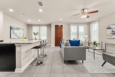Living room with recessed lighting, plenty of natural light, ceiling fan, and light tile patterned floors
