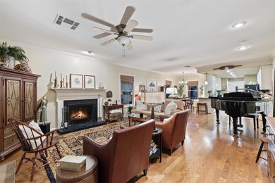 Living area featuring a ceiling fan, a tiled fire