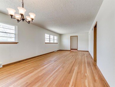 Spare room with an inviting chandelier, a textured