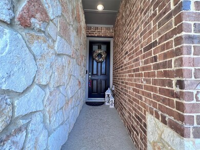 Charming front entry with elegant stone accents an