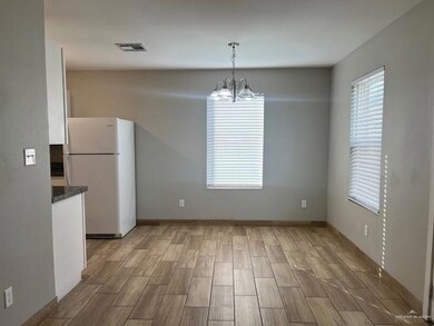 Unfurnished dining area with a chandelier and wood finished floors