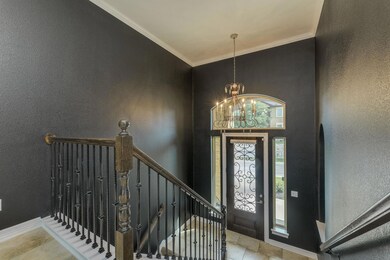 Entryway with a textured wall, baseboards, orname