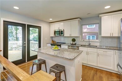 Center island kitchen with french doors to large d