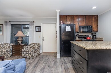 Kitchen featuring ornamental molding, black applia