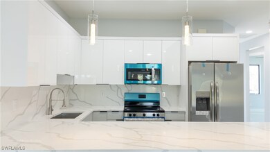 Kitchen featuring white cabinets, modern cabinets,