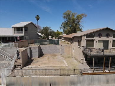 View of side of property with a fenced backyard, stucco siding, stairway, and a balcony