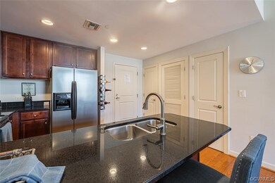 Kitchen featuring granite countertops, light hardw