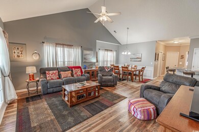 Living room featuring ceiling fan with notable cha