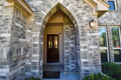 Front entry wood door with protected arched brick