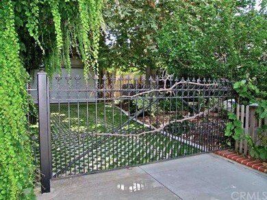 Gated entry through side yard to garages