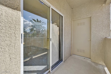 Property entrance with visible vents and stucco si
