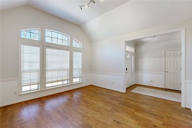 Spare room with baseboards, lofted ceiling, and ha