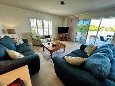 Living room featuring light tile patterned flooring and healthy amount of natural light