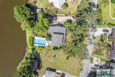 Aerial view of lot showcasing pool and water acces