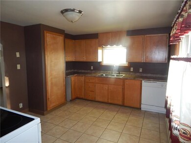 Lots of cabinets, double bowl sink and a dishwashe
