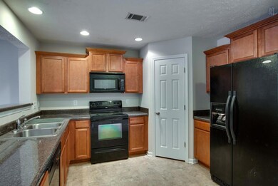 Spacious kitchen with a walk-in panty, tons of counter space and all appliances remain.