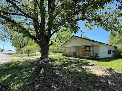 View of property exterior featuring covered porch 
