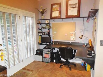 Junior Office. This office area is a very creative/convenient use of space! While it could be converted back to a breakfast area, the sellers have practically created another room by adding a desk for a computer, etc.  The large door/window allows light to flood in.
