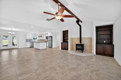 Unfurnished living room with a wood stove, built 