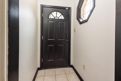 Doorway to outside featuring light tile floors